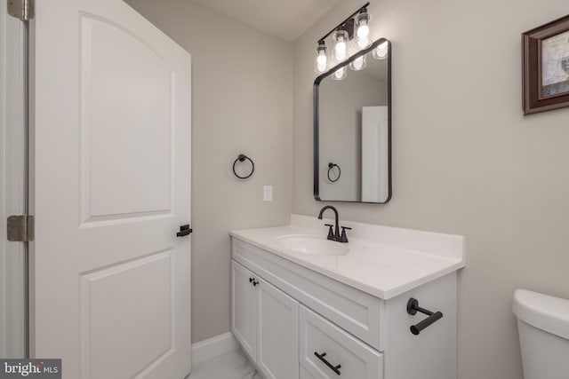 bathroom with vanity and toilet