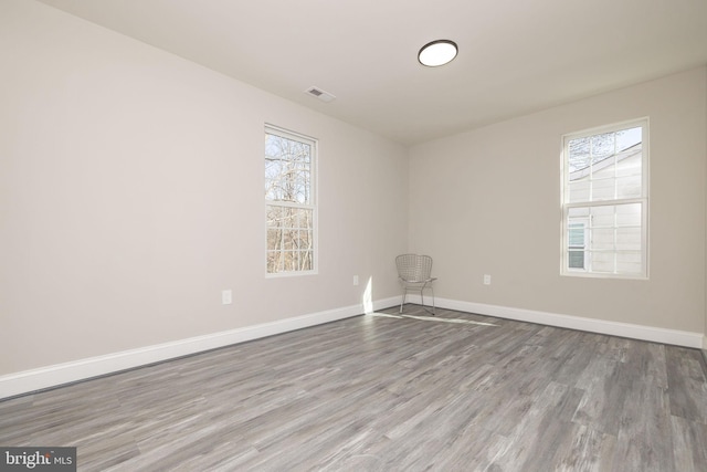 empty room with hardwood / wood-style floors