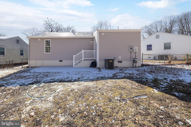 snow covered property with central air condition unit