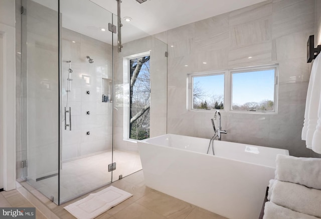 bathroom with independent shower and bath and tile walls