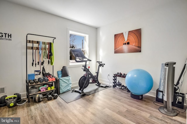 exercise room featuring light wood-type flooring