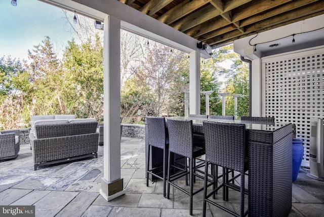 view of patio with an outdoor living space and central AC unit