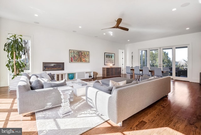 living room with hardwood / wood-style flooring, french doors, and ceiling fan