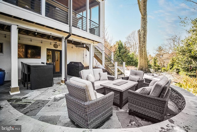 view of patio / terrace featuring a balcony, an outdoor living space, and a grill