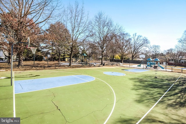 view of basketball court featuring a playground