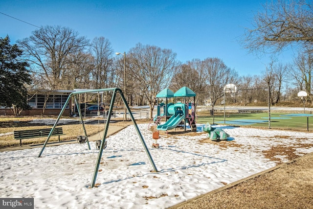 snow covered playground with basketball court