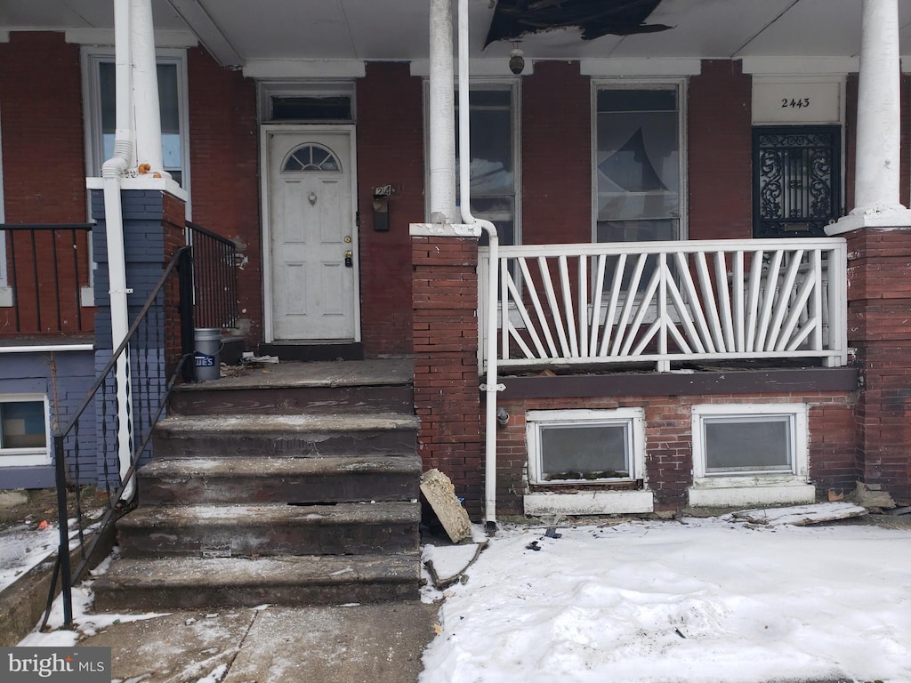 view of snow covered property entrance