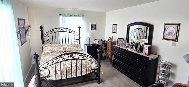 bedroom featuring light colored carpet