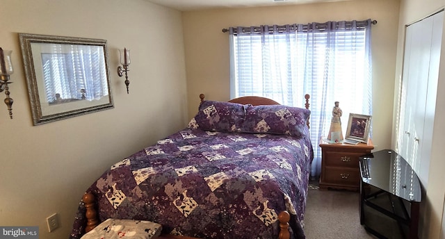 carpeted bedroom with a closet