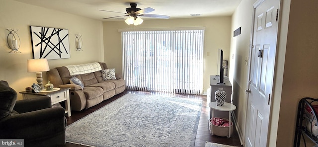 living room featuring dark hardwood / wood-style floors and ceiling fan