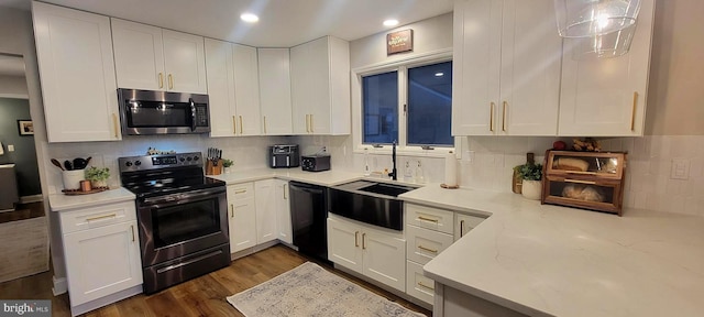 kitchen featuring sink, backsplash, stainless steel appliances, white cabinets, and dark hardwood / wood-style flooring