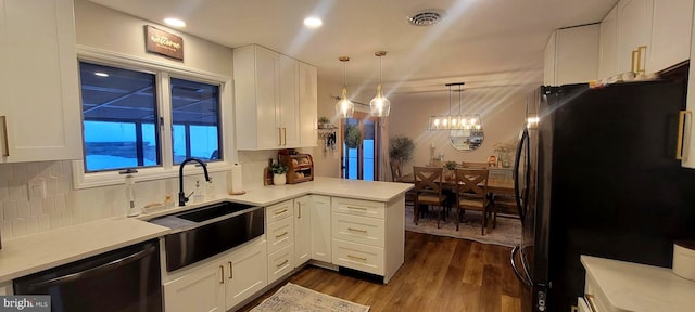 kitchen featuring tasteful backsplash, white cabinetry, black appliances, sink, and kitchen peninsula