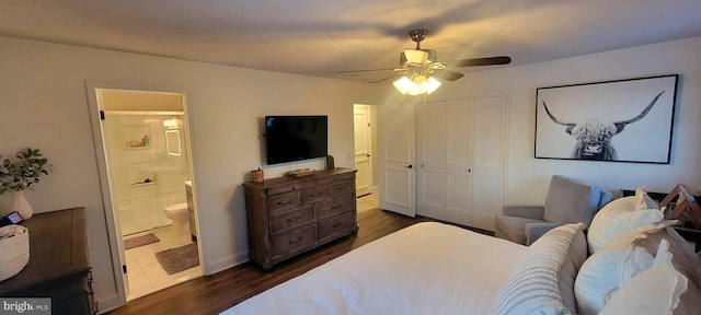 bedroom with connected bathroom, dark wood-type flooring, a closet, and ceiling fan