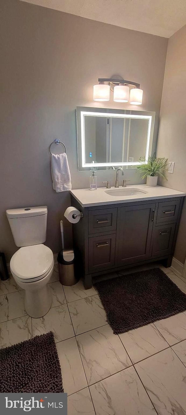 bathroom with vanity and toilet