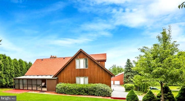 back of house featuring a sunroom and a yard