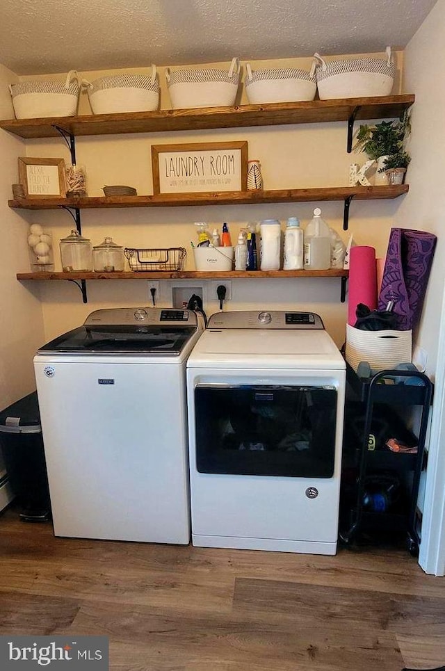 laundry area with washing machine and dryer and dark wood-type flooring