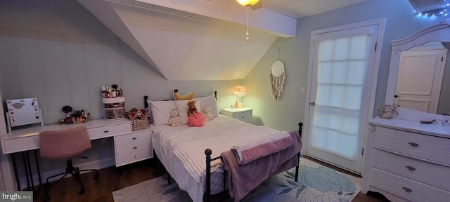 bedroom featuring lofted ceiling and dark hardwood / wood-style floors