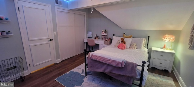 bedroom featuring lofted ceiling and dark hardwood / wood-style floors