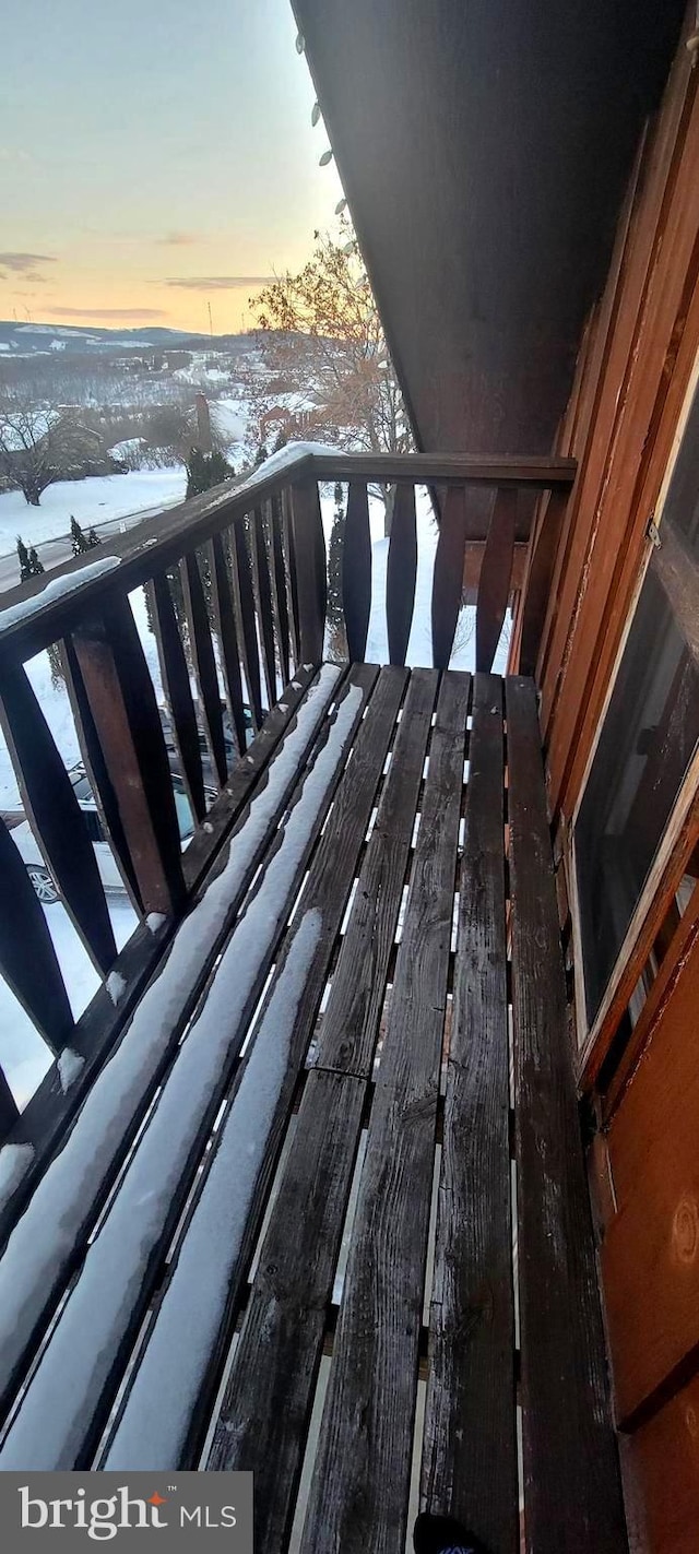 view of snow covered back of property