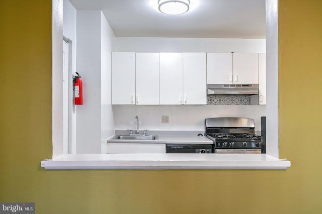 kitchen featuring stainless steel gas stove, sink, white cabinetry, and black dishwasher