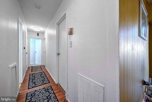 hallway with light hardwood / wood-style floors