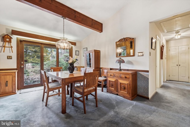 carpeted dining area featuring beam ceiling