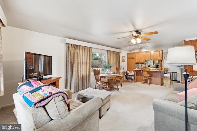 living room featuring light carpet and ceiling fan