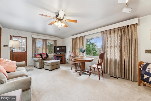 living room with ceiling fan, light colored carpet, and plenty of natural light