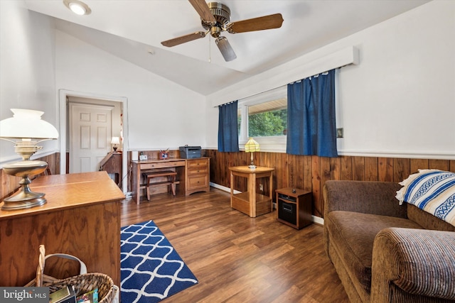 office space with wooden walls, ceiling fan, dark hardwood / wood-style flooring, and vaulted ceiling