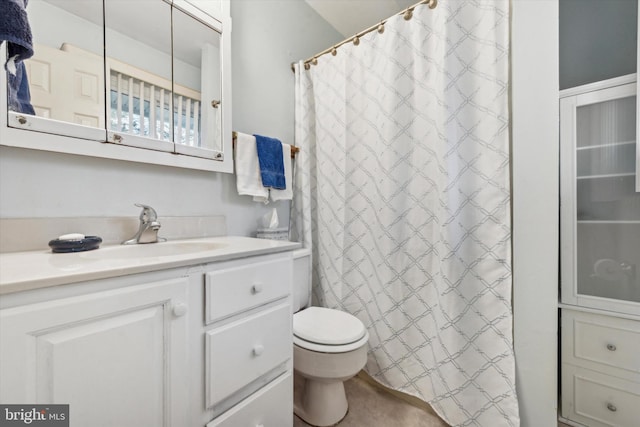 bathroom featuring vanity, curtained shower, and toilet