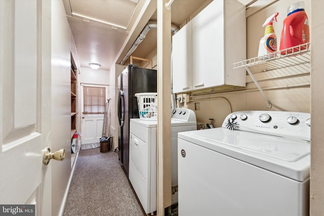 clothes washing area with washing machine and dryer and carpet flooring