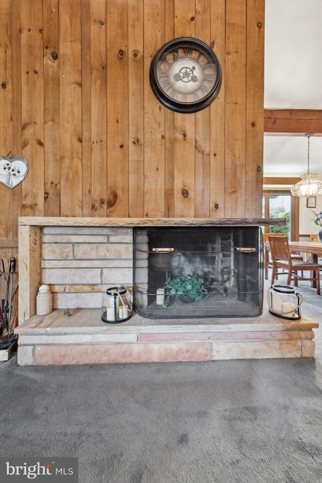 room details featuring wood walls and carpet