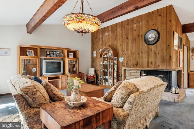 living room featuring beamed ceiling, carpet, and wooden walls