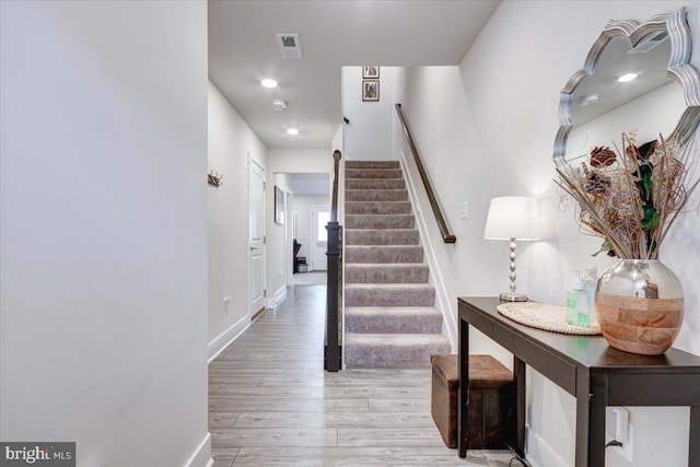 stairway with hardwood / wood-style flooring