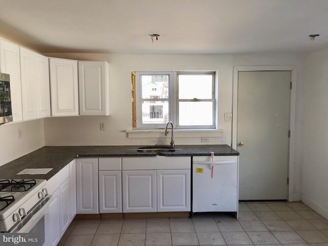 kitchen with white cabinetry, sink, light tile patterned floors, and white appliances