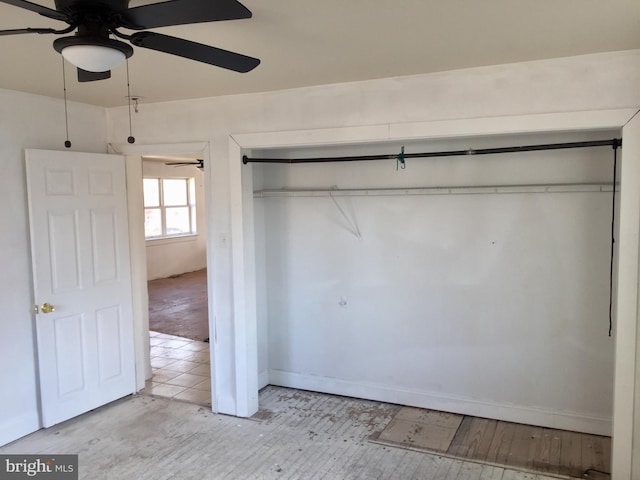 unfurnished bedroom with a closet and ceiling fan