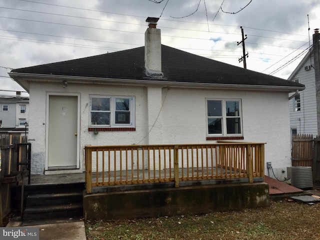 rear view of house with a wooden deck and central AC unit