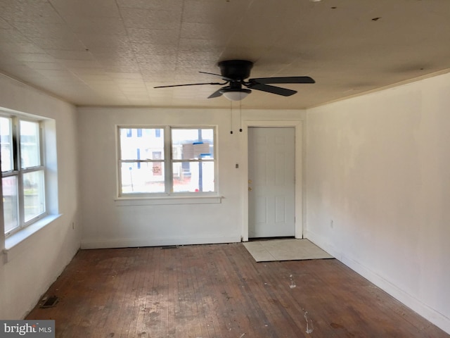 spare room with hardwood / wood-style floors and ceiling fan