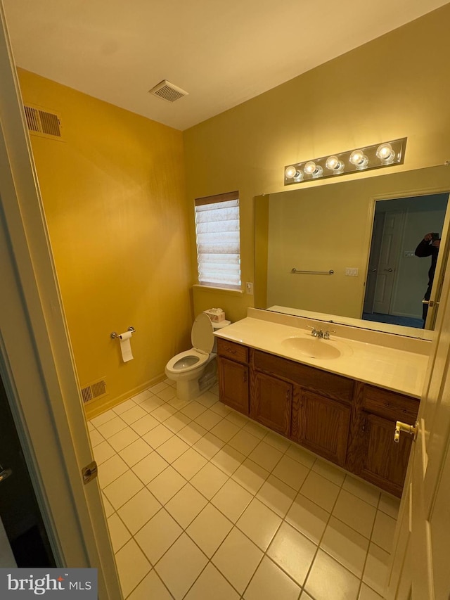 bathroom with vanity, toilet, and tile patterned flooring