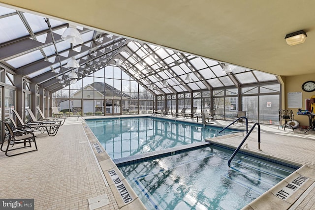 view of pool with a lanai, a patio area, and an indoor in ground hot tub