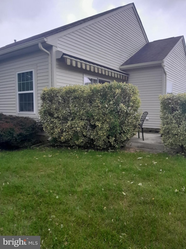 view of home's exterior with a lawn