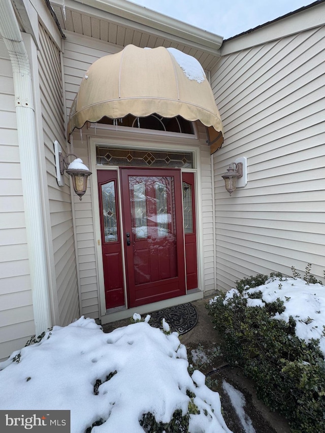 view of snow covered property entrance