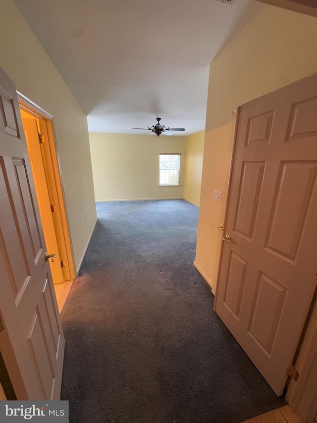 hall featuring carpet flooring