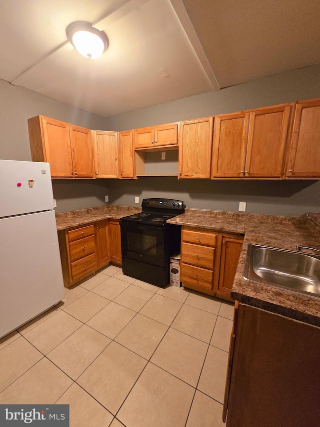 kitchen featuring white refrigerator, light tile patterned flooring, sink, and electric range