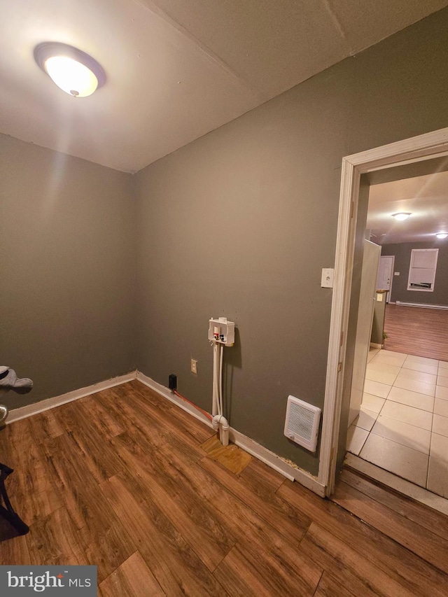 laundry room with washer hookup and hardwood / wood-style floors