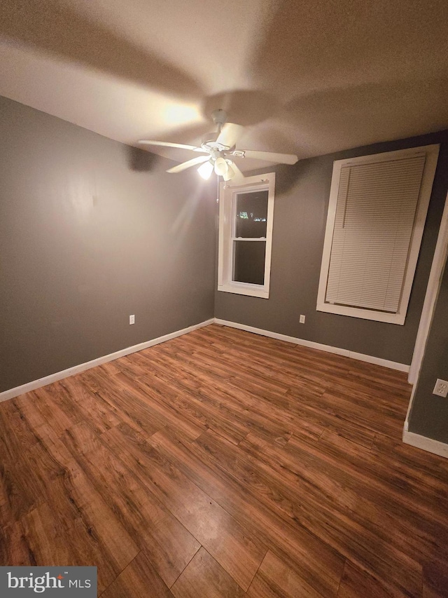 unfurnished bedroom featuring ceiling fan, dark hardwood / wood-style flooring, and a textured ceiling