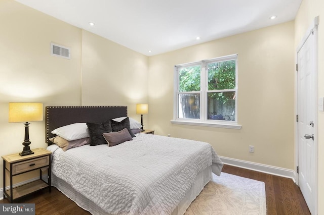 bedroom with dark wood-type flooring