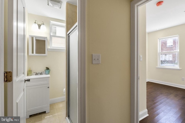 bathroom with vanity, toilet, and walk in shower