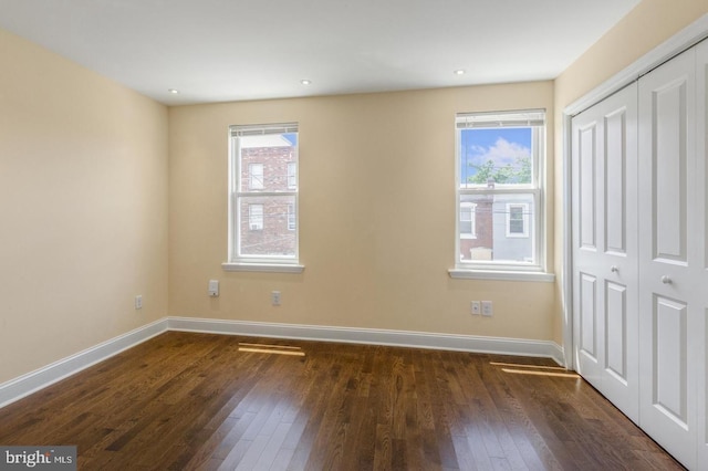 unfurnished bedroom featuring dark hardwood / wood-style floors