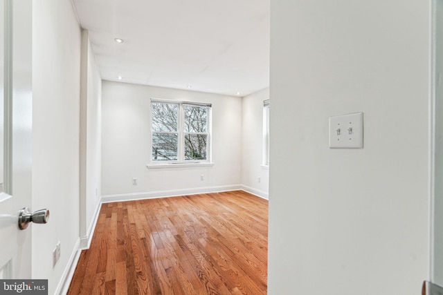 unfurnished room with wood-type flooring